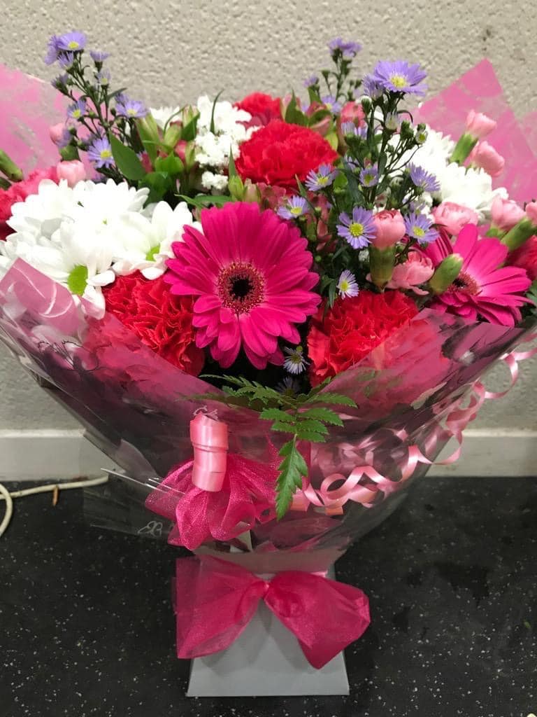 Hand tied fuchsia arrangement